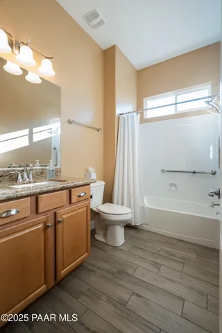 a bathroom with a sink a toilet and a shower