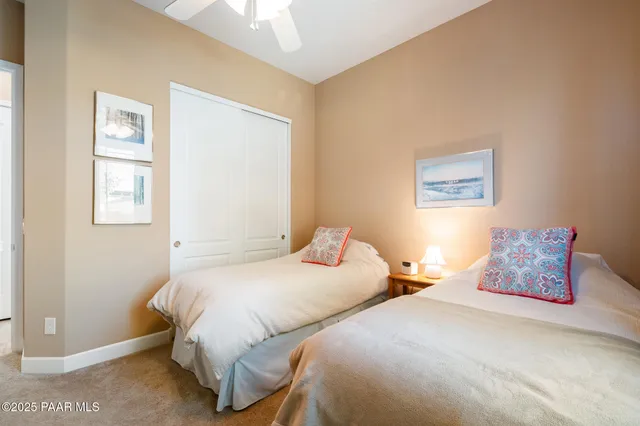 a bedroom with two beds and a window