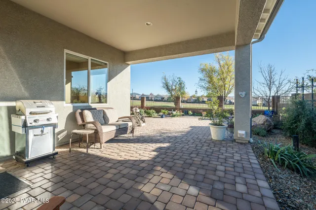 a living room with furniture a window and a flat screen tv