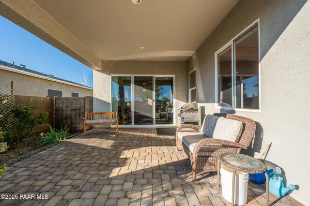 a view of a patio with table and chairs and potted plants