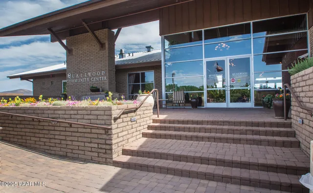 a living room with furniture a rug and a large window