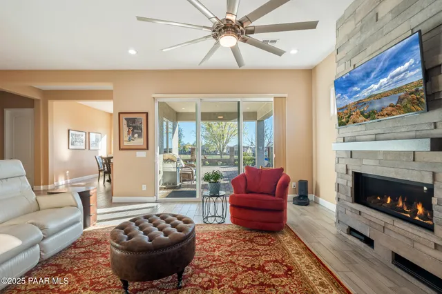 a living room with furniture a fireplace and a table