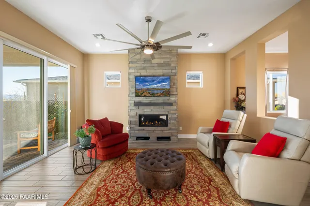 a living room with furniture a fireplace and a chandelier
