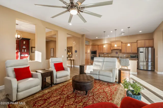 a living room with furniture and a view of kitchen