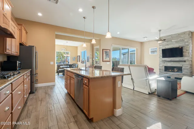 a large kitchen with stainless steel appliances lots of counter space and windows