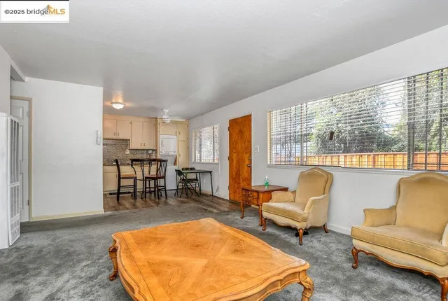 a kitchen with stainless steel appliances a stove a refrigerator a table and chairs