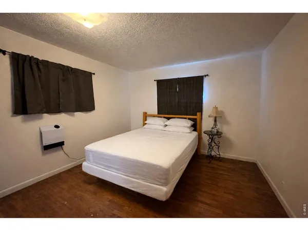 a bed sitting in a bedroom and table