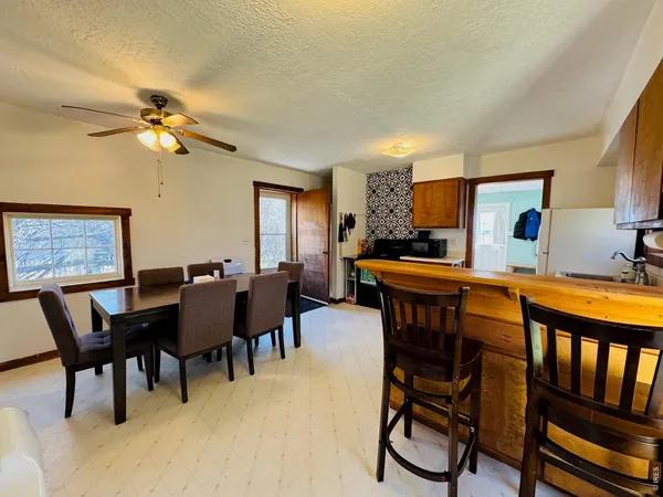 a view of a dining room with furniture and chandelier