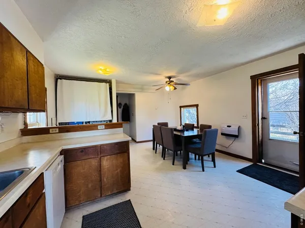 a view of a dining room with furniture and window
