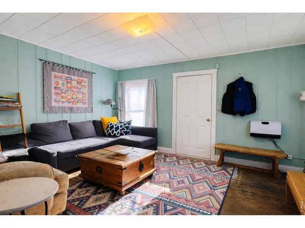 a living room with furniture and a rug