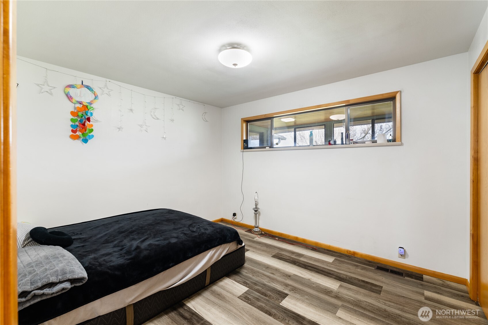 21563-21567 Cook Road Sedro-Woolley, WA 98284 - Photo 16 of 38 a bedroom with a bed and wooden floor