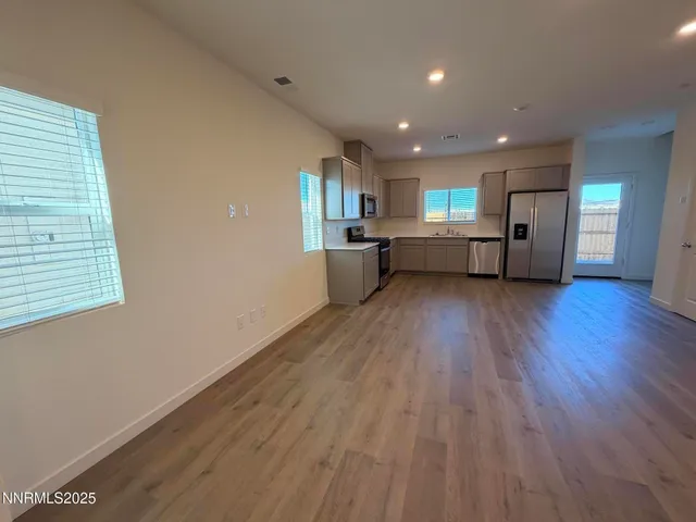 a view of a kitchen with a sink and wooden floor