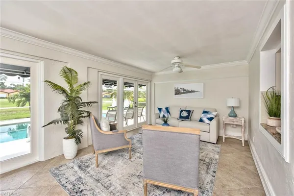 a living room filled with furniture a rug and a window