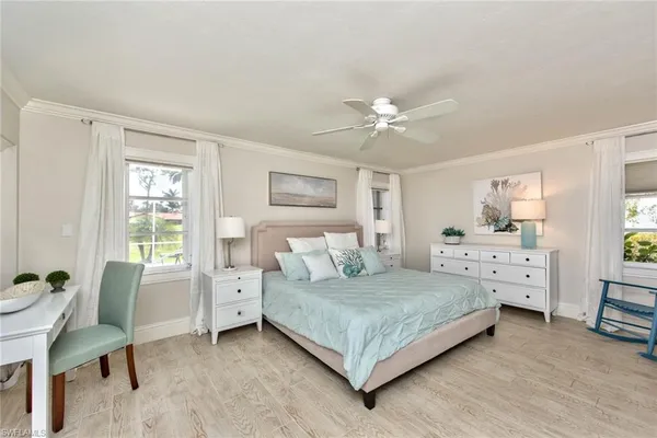 a bedroom with a bed and a table chair in it