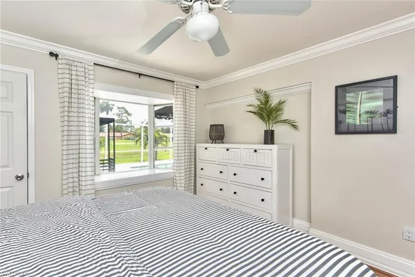 a bedroom with a bed dresser and a window