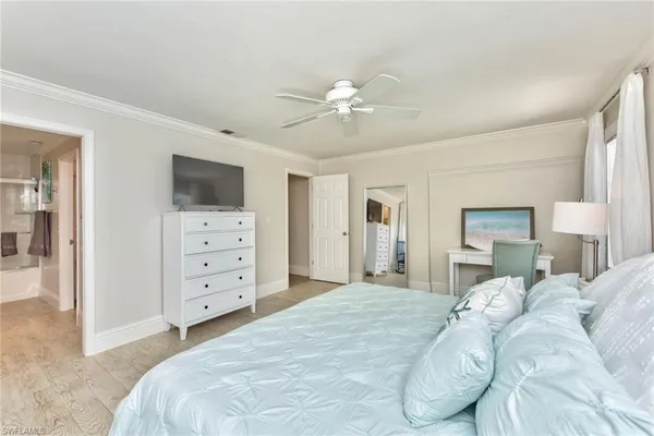 a bedroom with a large bed and a tv