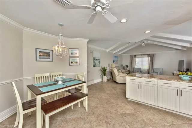 a kitchen that has a lot of cabinets a sink and appliances