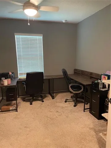 a view of a workspace with furniture