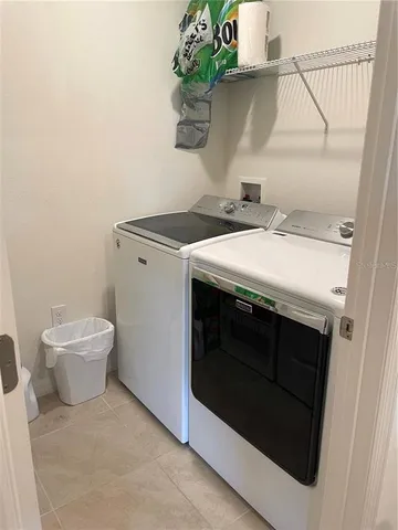 a utility room with a stove and a sink