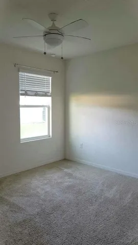 an empty room with a empty space and windows
