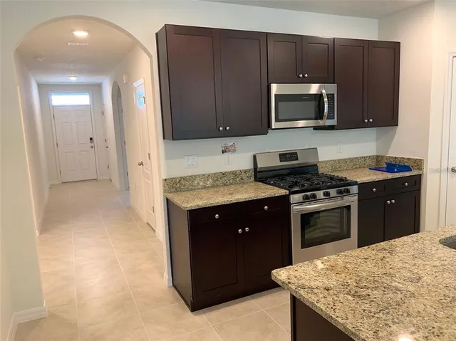 a kitchen with a sink stove and microwave