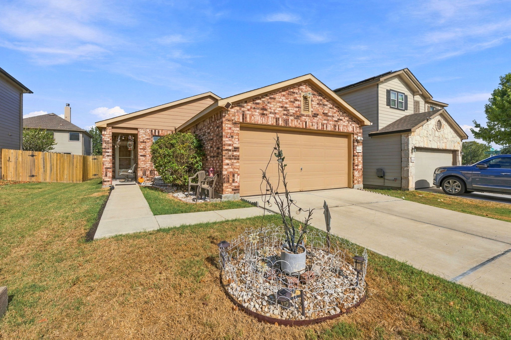 9004 Wiley Way Austin, TX 78747 - Photo 2 of 39 A classic brick exterior and a concrete driveway define this single-story suburban residence.
