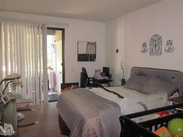 735 Arneill Road Camarillo, CA 93010 - Photo 11 of 21 a bedroom with a bed and wooden floor