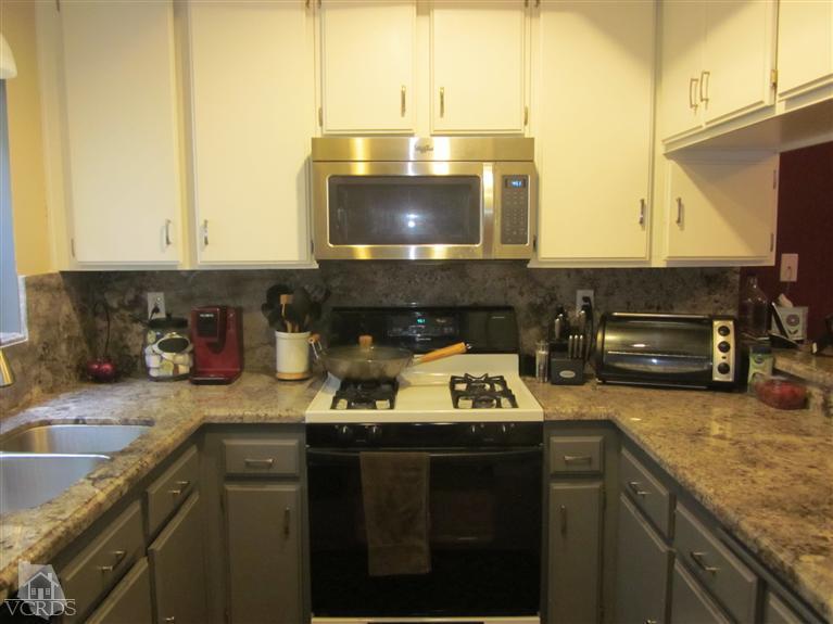 735 Arneill Road Camarillo, CA 93010 - Photo 4 of 21 a kitchen with a sink a stove and a microwave