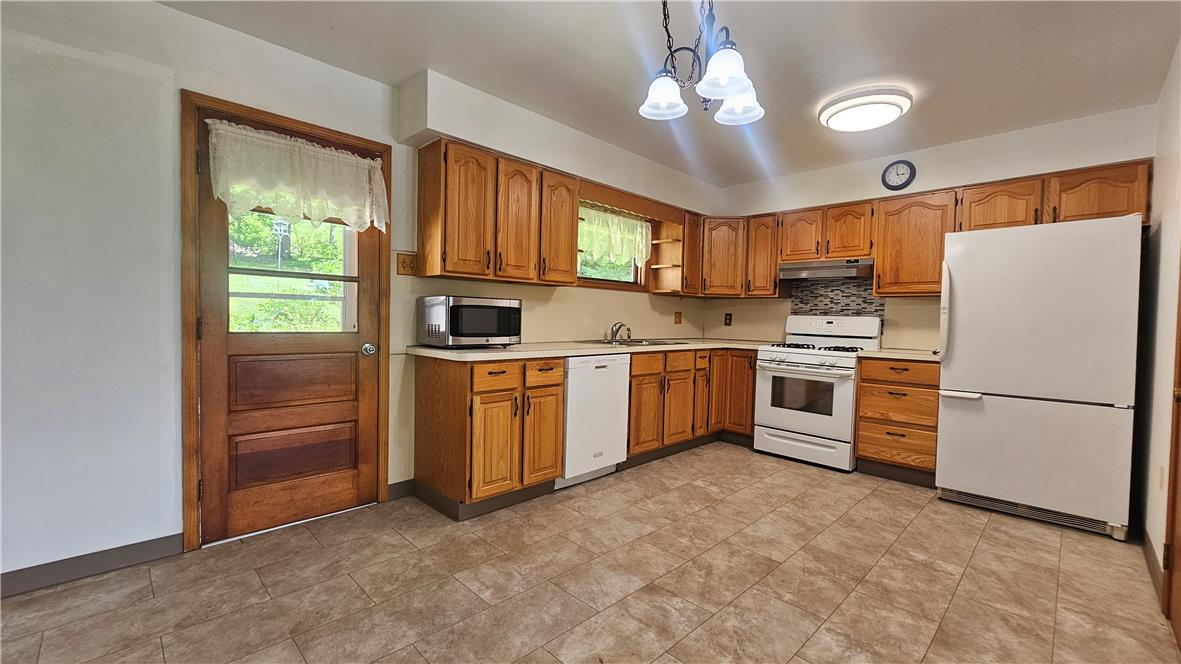 2529 Ringhoffer Road Hellertown, PA 18055 - Photo 5 of 33 A well-maintained kitchen showcases ample wood cabinetry and white appliances, perfect for everyday living.