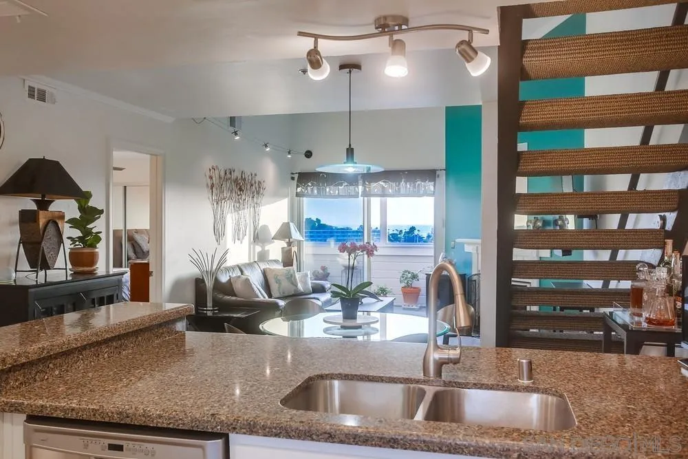 157 Mangano Circle Encinitas, CA 92024 - Photo 4 of 28 a kitchen with a sink a counter and cabinets