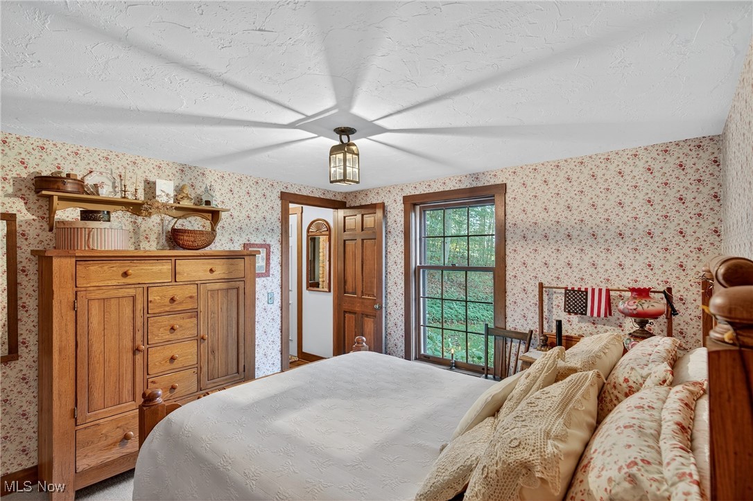 25700 Winona Road Homeworth, OH 44634 - Photo 16 of 49 Bedroom featuring wallpapered walls and a textured ceiling
