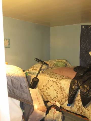 a bedroom with a bed and pillows