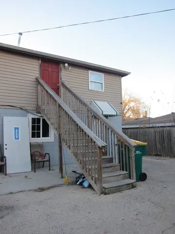 a view of backyard with deck and wooden fence