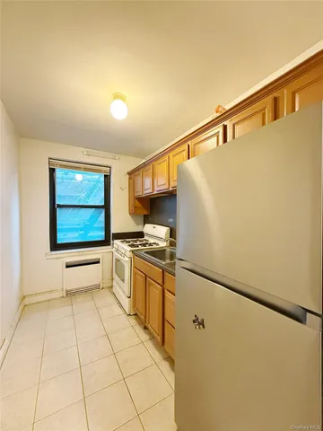 a kitchen with stainless steel appliances a refrigerator and a stove top oven