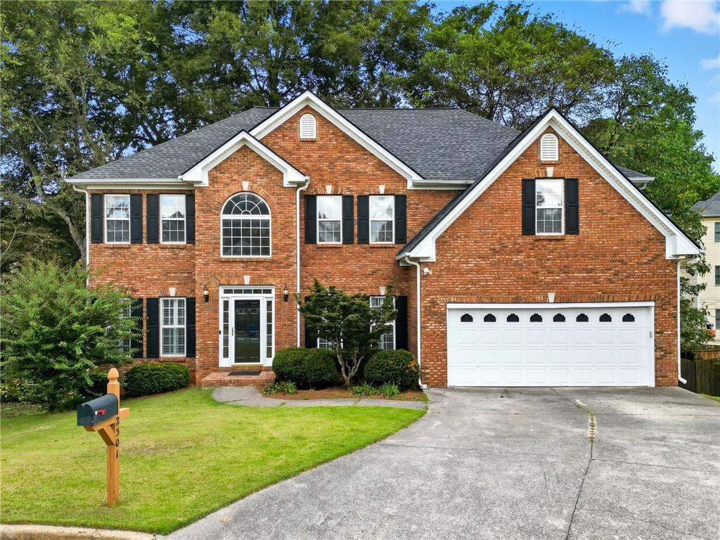 2301 Alexander Farms Court Southwest Marietta, GA 30064 - Photo 1 of 62 a front view of a house with a yard and garage