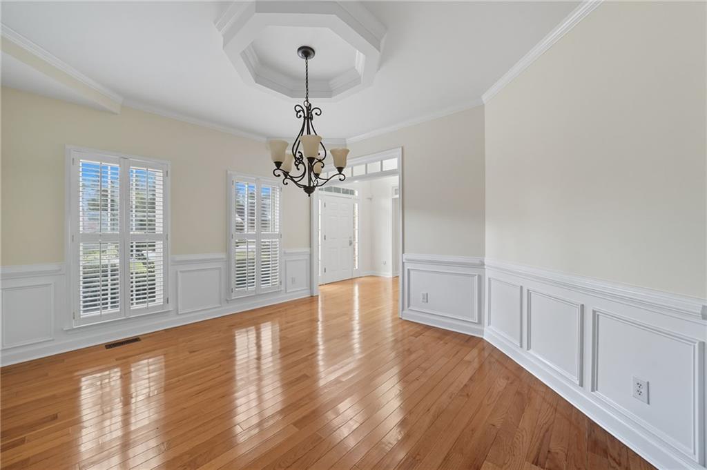 2301 Alexander Farms Court Southwest Marietta, GA 30064 - Photo 17 of 62 a view of an empty room with chandelier and wooden floor