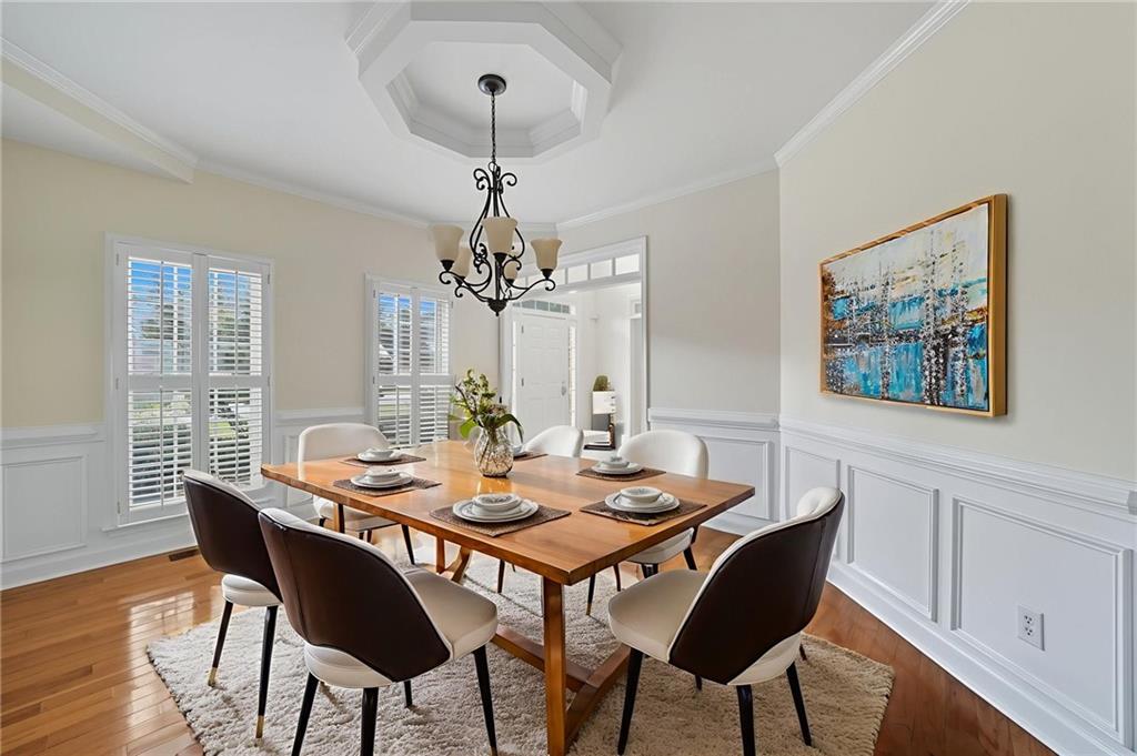 2301 Alexander Farms Court Southwest Marietta, GA 30064 - Photo 18 of 62 a view of a dining room with furniture a chandelier and wooden floor