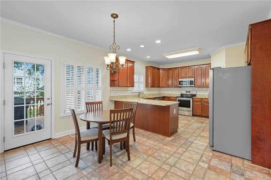 2301 Alexander Farms Court Southwest Marietta, GA 30064 - Photo 20 of 62 a kitchen with a table chairs and microwave