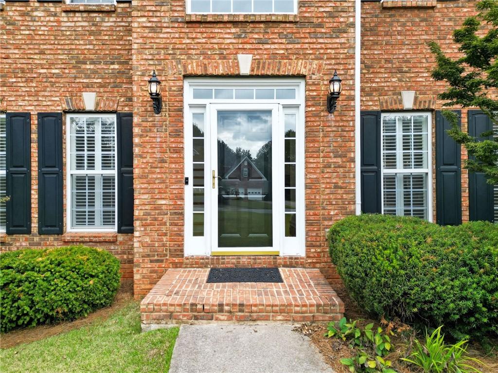 2301 Alexander Farms Court Southwest Marietta, GA 30064 - Photo 2 of 62 front view of a brick house with a yard