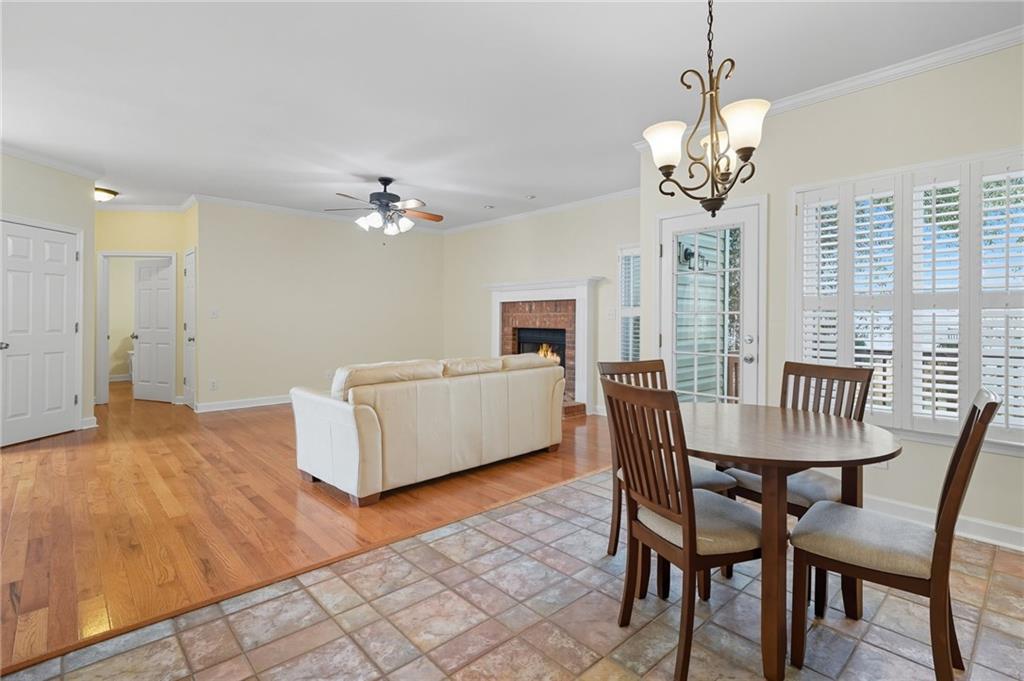 2301 Alexander Farms Court Southwest Marietta, GA 30064 - Photo 28 of 62 a view of a dining room with furniture a chandelier and wooden floor