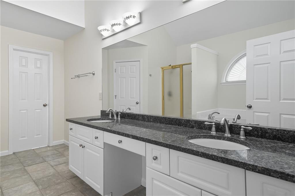 2301 Alexander Farms Court Southwest Marietta, GA 30064 - Photo 42 of 62 a bathroom with a granite countertop double sink and a mirror