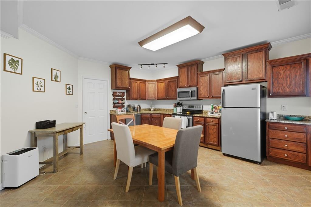 2301 Alexander Farms Court Southwest Marietta, GA 30064 - Photo 59 of 62 a kitchen with a refrigerator a dining table and chairs