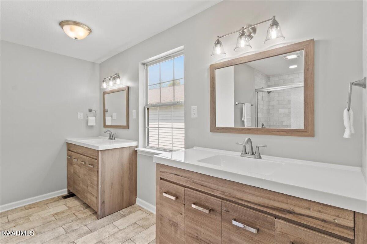 316 Granite Road Clinton, TN 37716 - Photo 13 of 26 a bathroom with a double vanity sink and a mirror