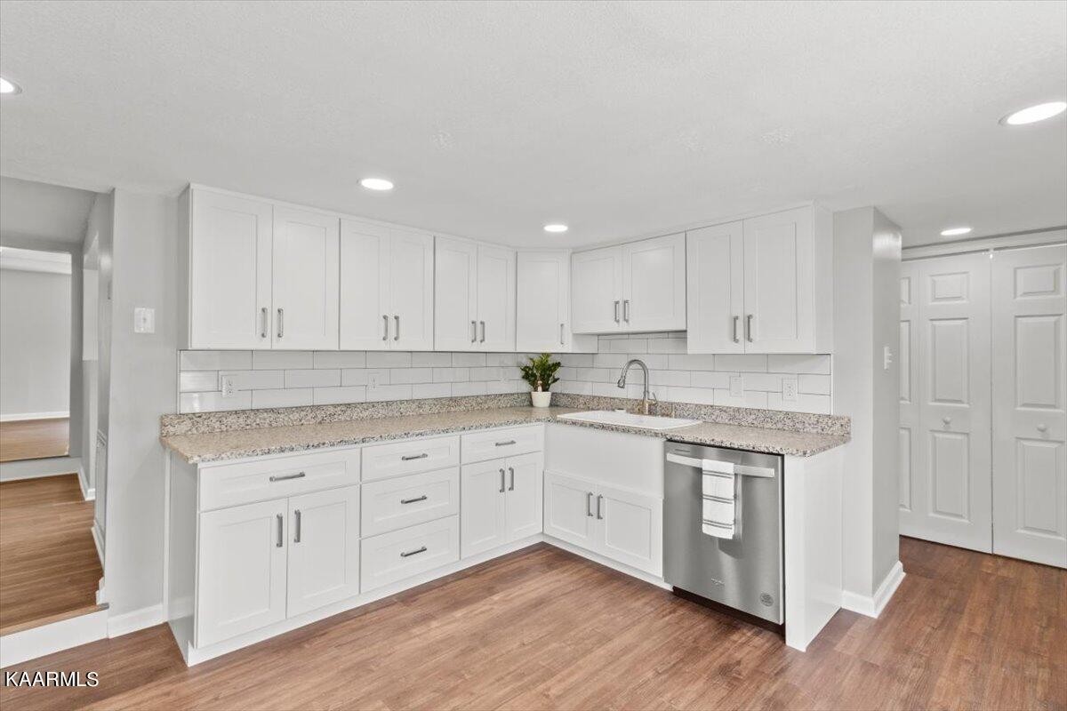 316 Granite Road Clinton, TN 37716 - Photo 16 of 26 a kitchen with granite countertop white cabinets and white appliances