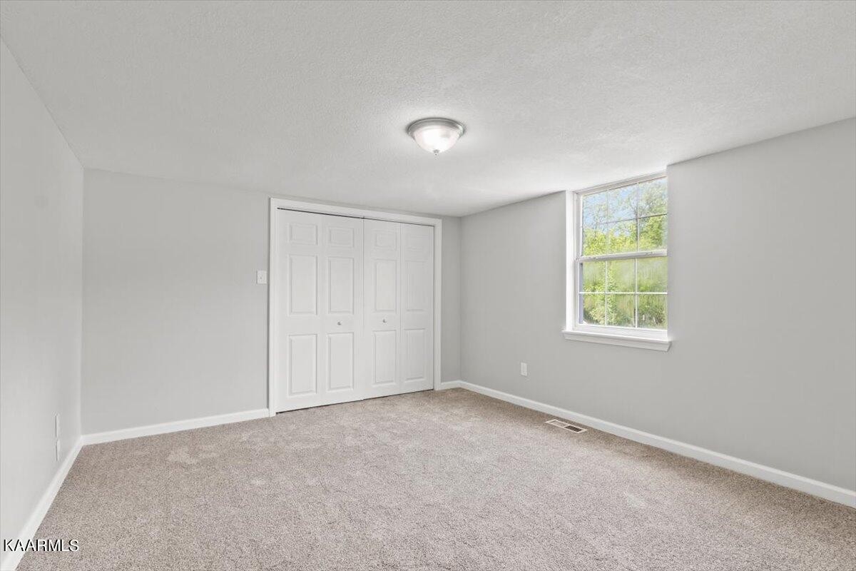 316 Granite Road Clinton, TN 37716 - Photo 18 of 26 an empty room with windows