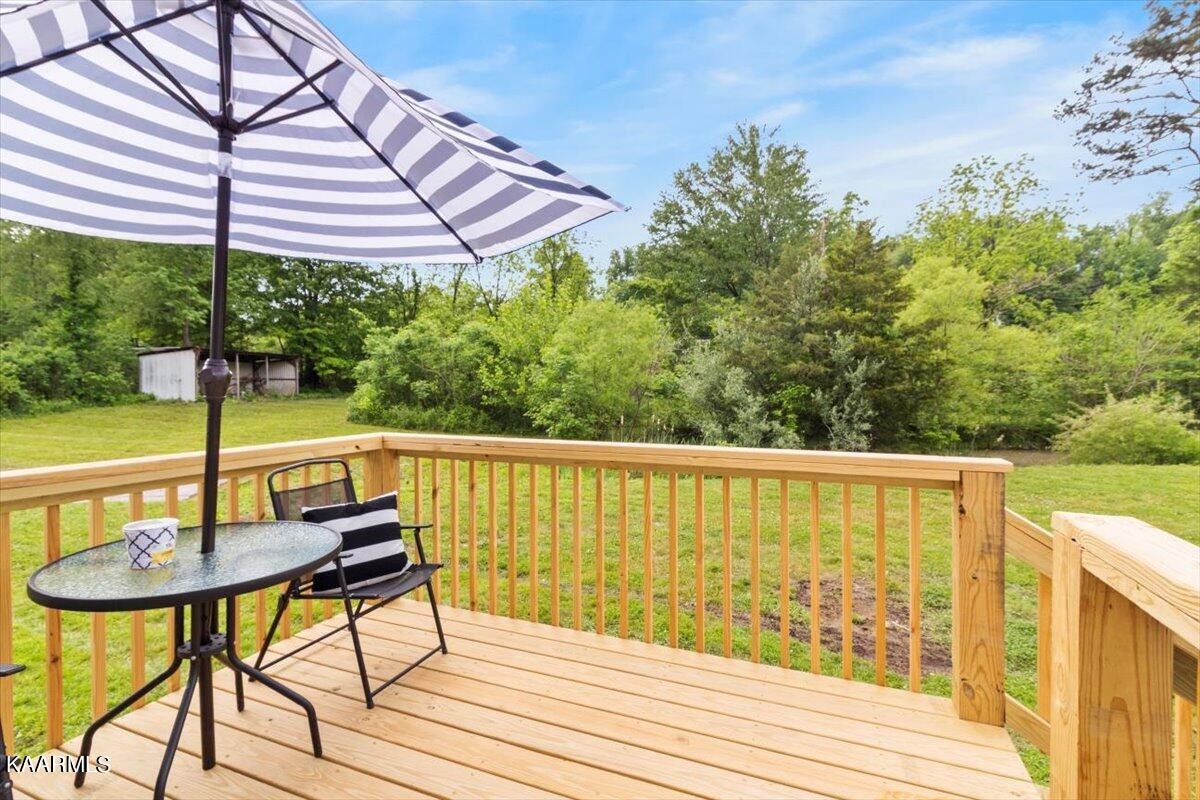 316 Granite Road Clinton, TN 37716 - Photo 21 of 26 a view of balcony with wooden floor and outdoor seating