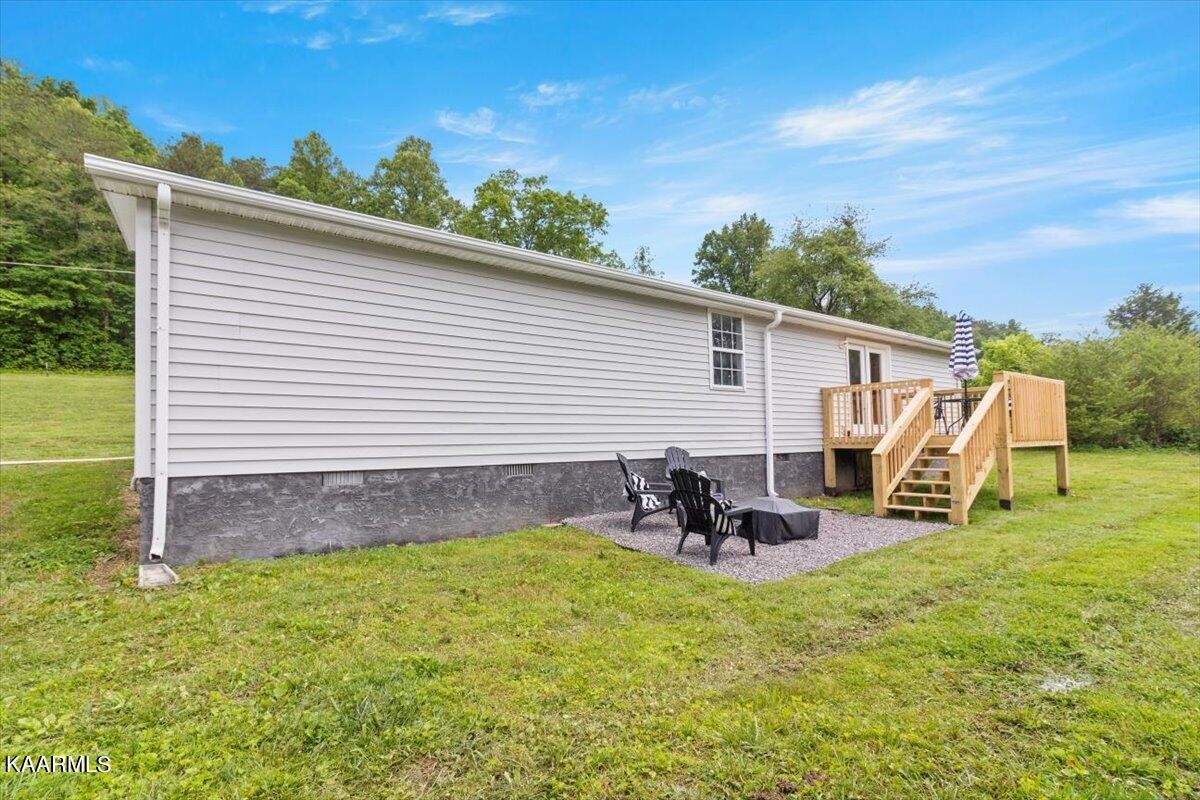 316 Granite Road Clinton, TN 37716 - Photo 22 of 26 a view of a backyard with chairs and a grill
