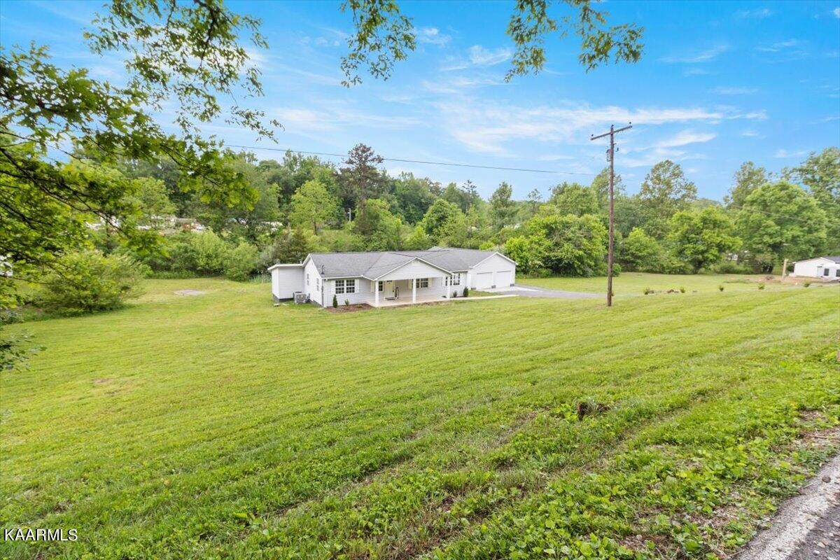 316 Granite Road Clinton, TN 37716 - Photo 25 of 26 a view of a big yard with swimming pool and large trees