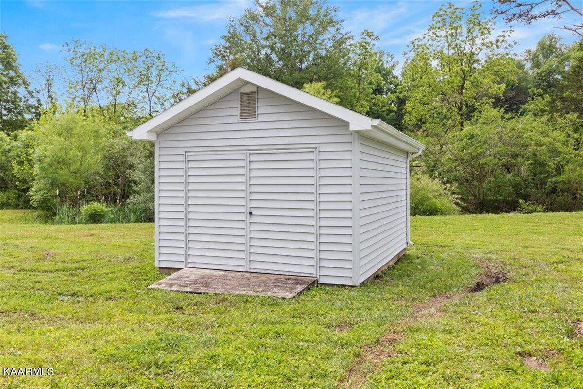 316 Granite Road Clinton, TN 37716 - Photo 4 of 26 a view of a backyard with a garden