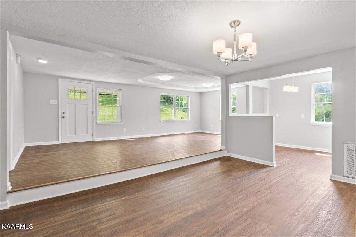 316 Granite Road Clinton, TN 37716 - Photo 8 of 26 a view of an empty room with a window and wooden floor